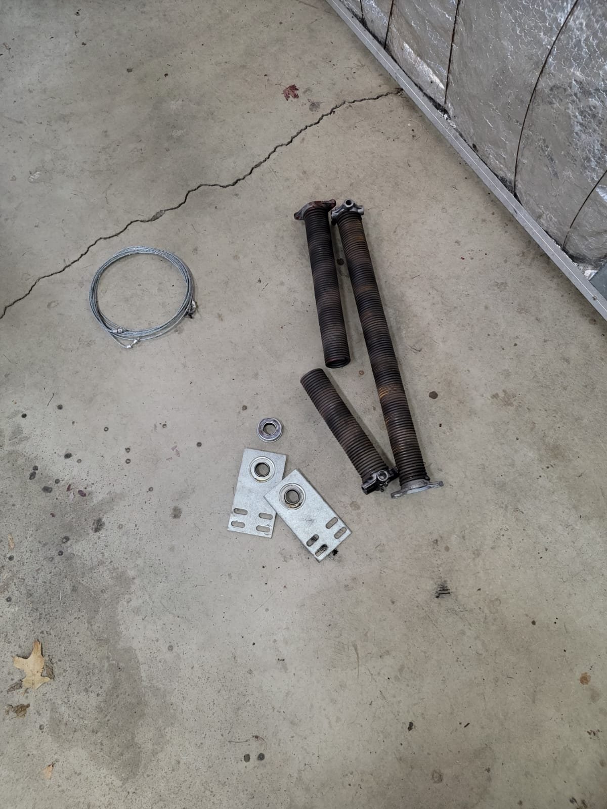"Close-up of a technician performing garage door spring repair for a residential overhead garage door in Dublin, Ohio."
