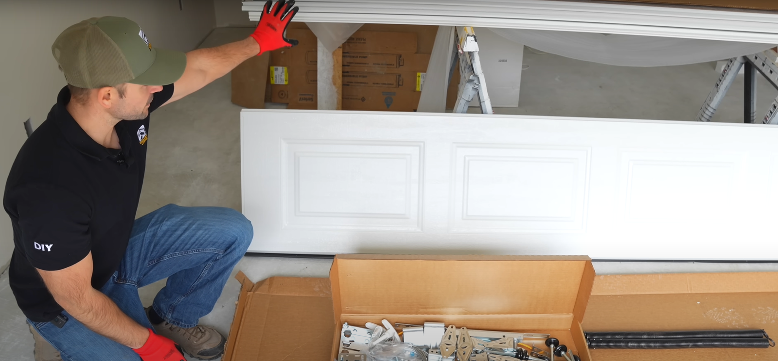 Technician performing a section replacement on an overhead garage door in Dublin, Ohio for professional repair services