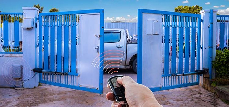 "Technician repairing an automated gate system with tools, representing professional overhead garage door repair services in Dublin, Ohio."